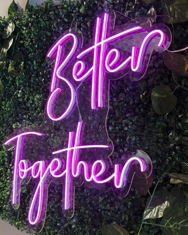 Şeffaf taşıyıcı üzerinde mor ışıklı Better Together neon yazısı.